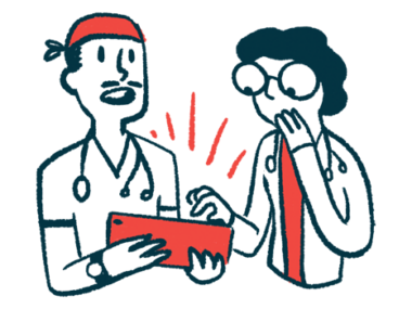 Two medical professionals look at a tablet one is holding, while talking.