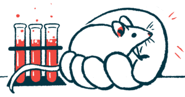 A mouse is held in a hand near test tubes in a lab.